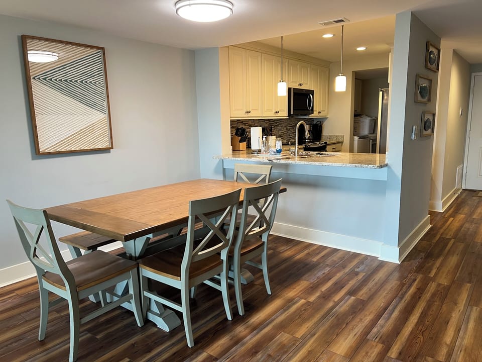Dining area w/ kitchen in background