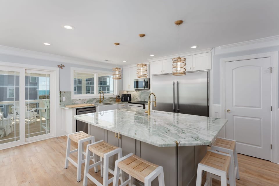 Exotic quartzite, custom professional grade appliances, and well stocked kitchen