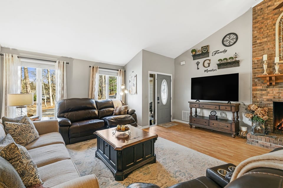 Living room with 2 reclining sofas, and grand piano for musicians/music lovers!
