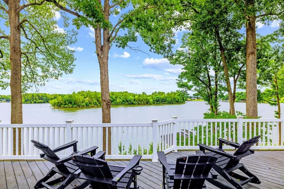 The deck wraps the home in outdoor living space and water views.