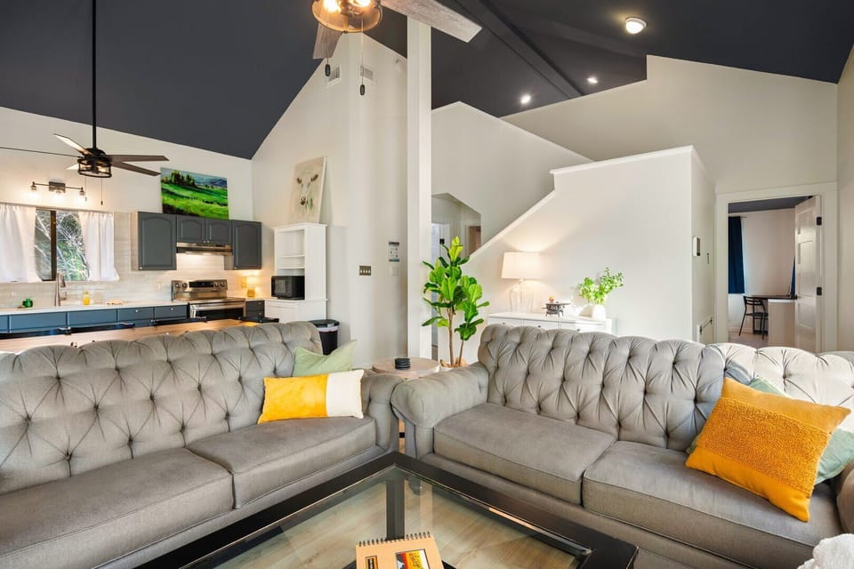 Living room foreground, staircase to loft behind