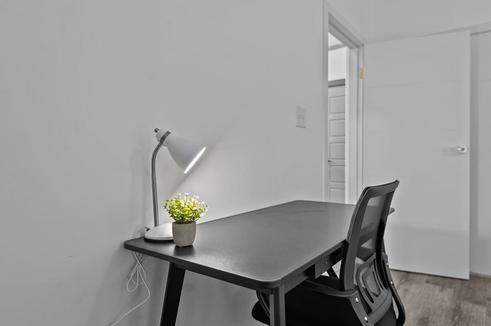 Desk is located in the bedroom, which does have a door for privacy.