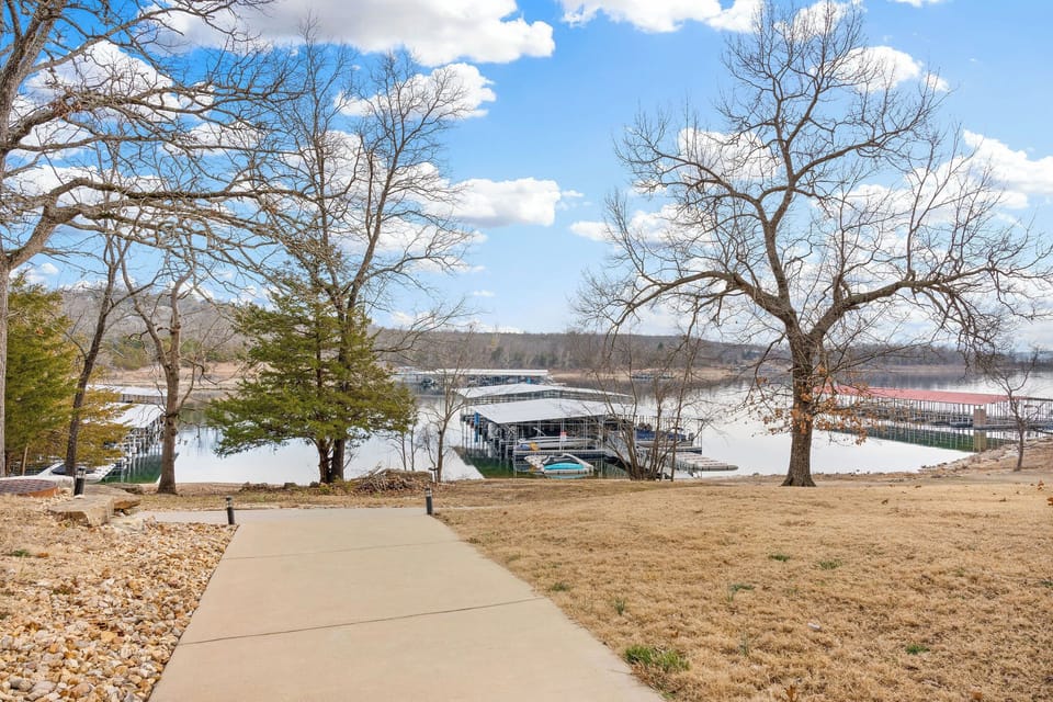 Paved path leads you to the water's edge and boat slips, ideal for lakefront adventures.