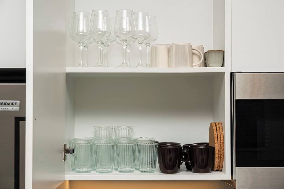 Fully stocked with plates, bowls, coffee mugs, and glassware for the whole group.