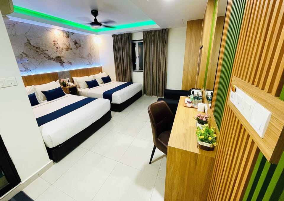 Deluxe Family Room | Minibar, in-room safe, desk, laptop workspace