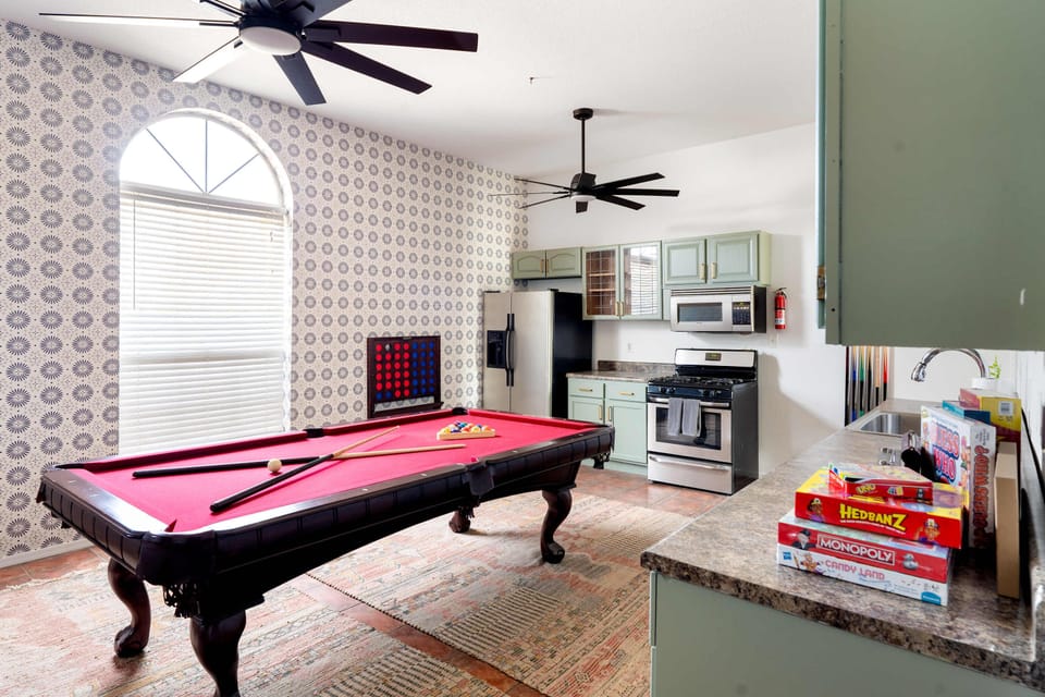A fully stocked kitchen for meals, connected to a game room packed with fun—pool table, shuffleboard, Connect 4, and more!