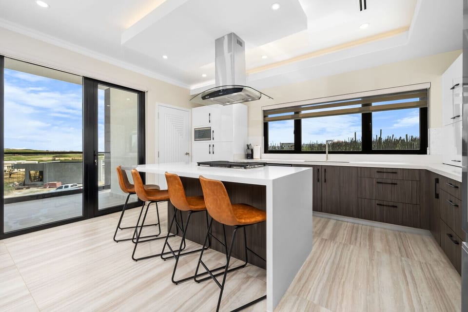 Whip up meals in style in this modern kitchen—complete with sleek finishes, a spacious island, and plenty of natural light.
