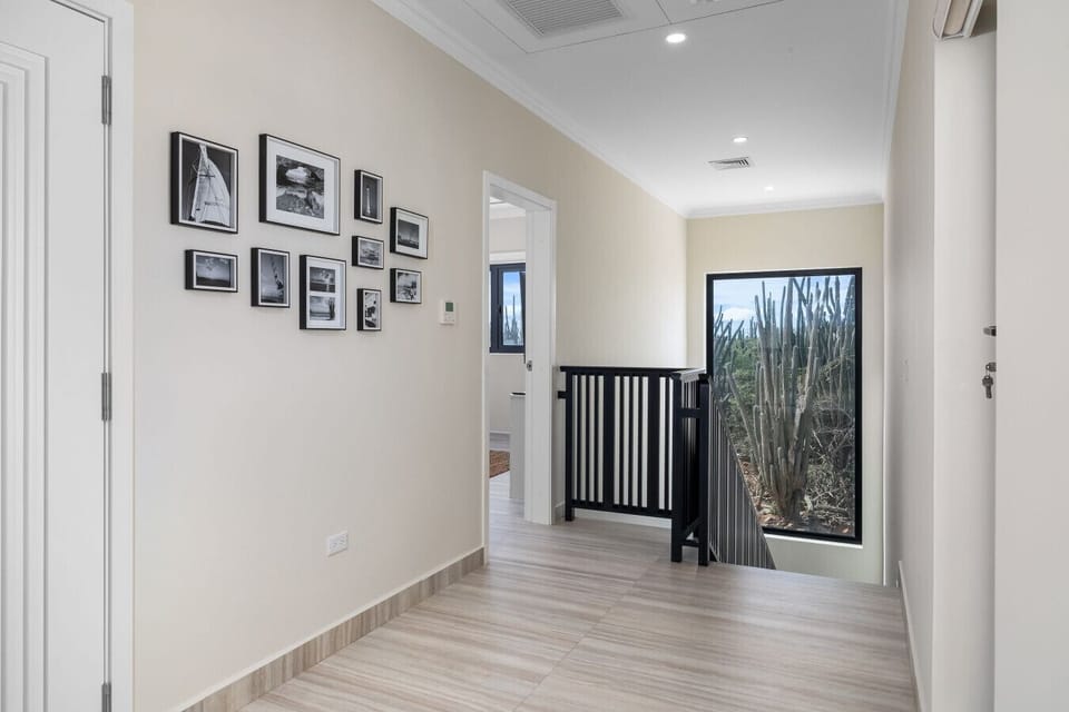 Bright hallway with desert views and a gallery wall that adds a personal touch.