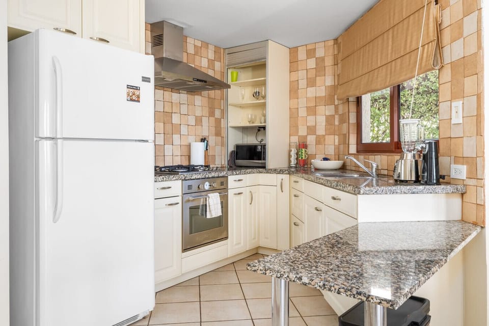 Whip up your favorite meals in this well-equipped kitchen, where functionality meets a warm, inviting design