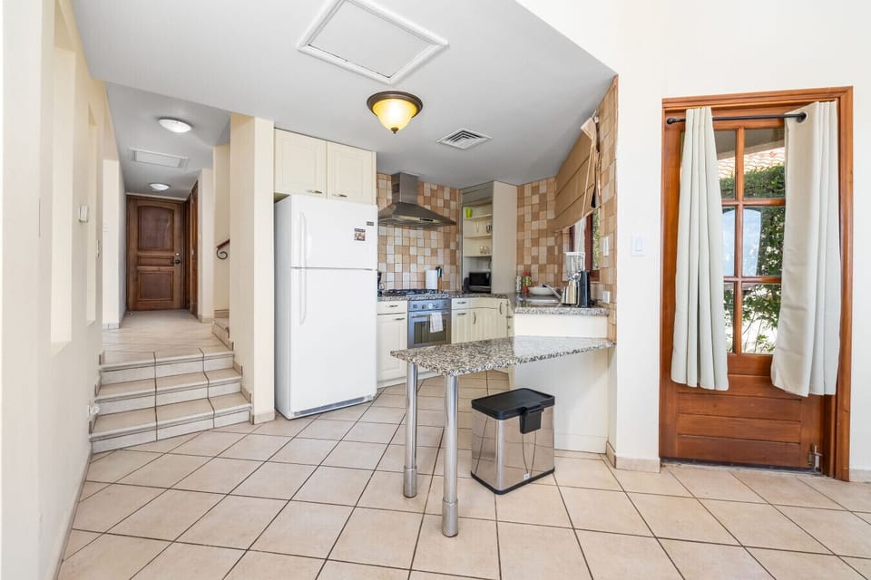 Welcome to a cozy kitchen that blends style and convenience, making cooking a pleasure in this charming space.