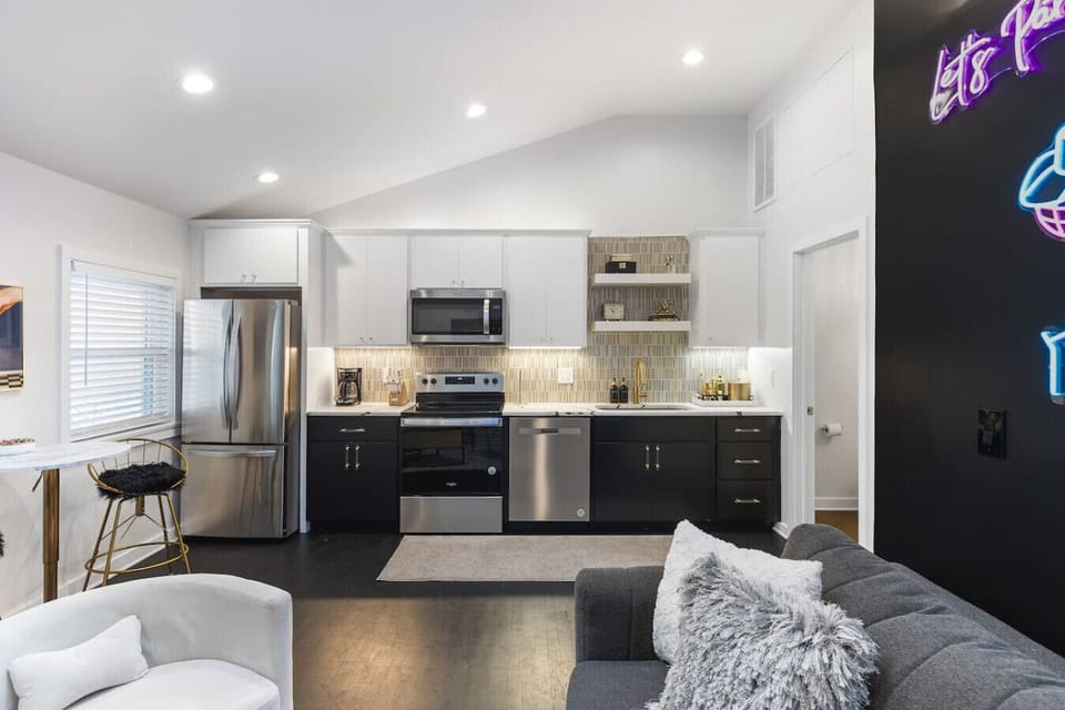 Fully equipped kitchen with all your cooking essentials, drip coffee maker + coffee. Dining table with seating for 2. This room opens up into the living room. Chic colors, neon lights and decor all throughout the condo.
