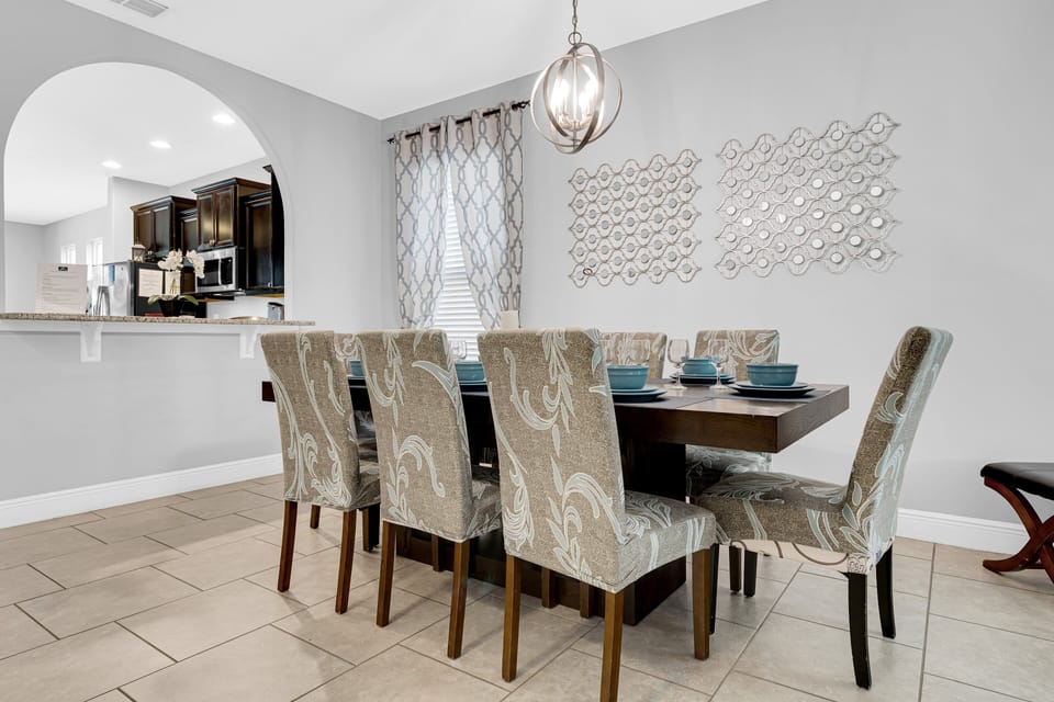 The dining room includes a spacious table with comfortable seating for eight guests