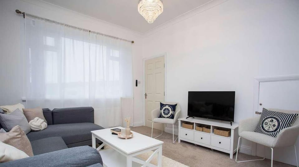 Stylish living room with soft tones, modern décor, and plenty of natural light.