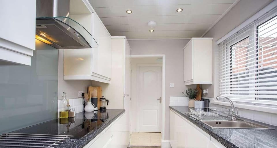 Bright and beautifully designed kitchen with ample counter space and storage.
