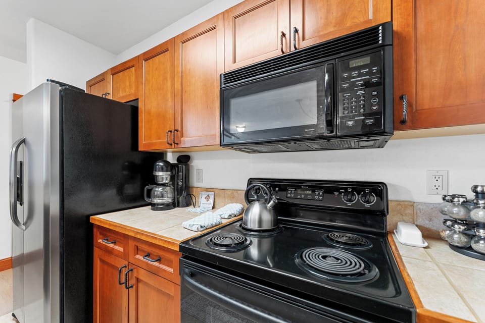 Your fully equipped kitchen features warm wood cabinets, modern appliances, and everything you need to prepare delicious meals during your stay.