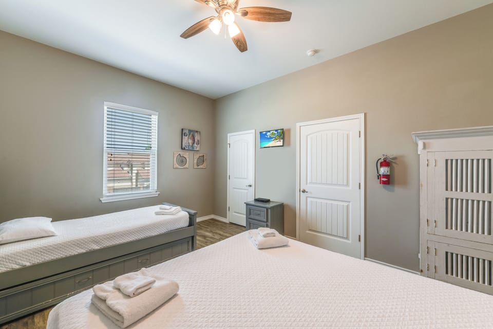 Rest peacefully in your comfortable twin bedroom with soft linens and gentle ceiling fan breeze keeping you cool.