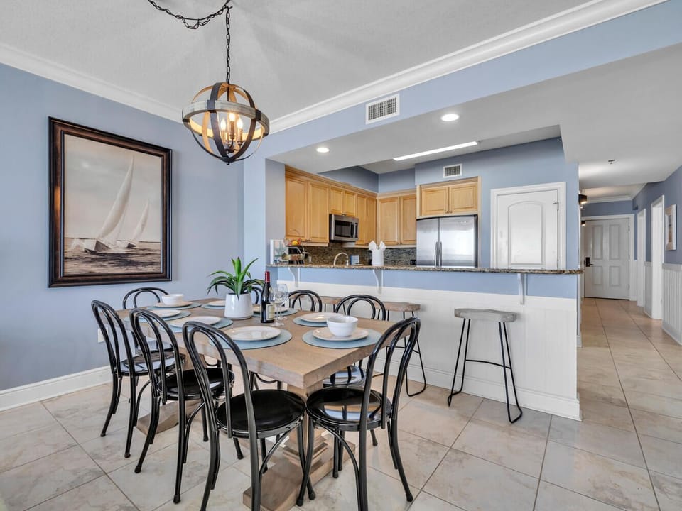 Gather around your beautifully appointed dining table where memorable meals await, perfectly connected to your fully equipped kitchen.