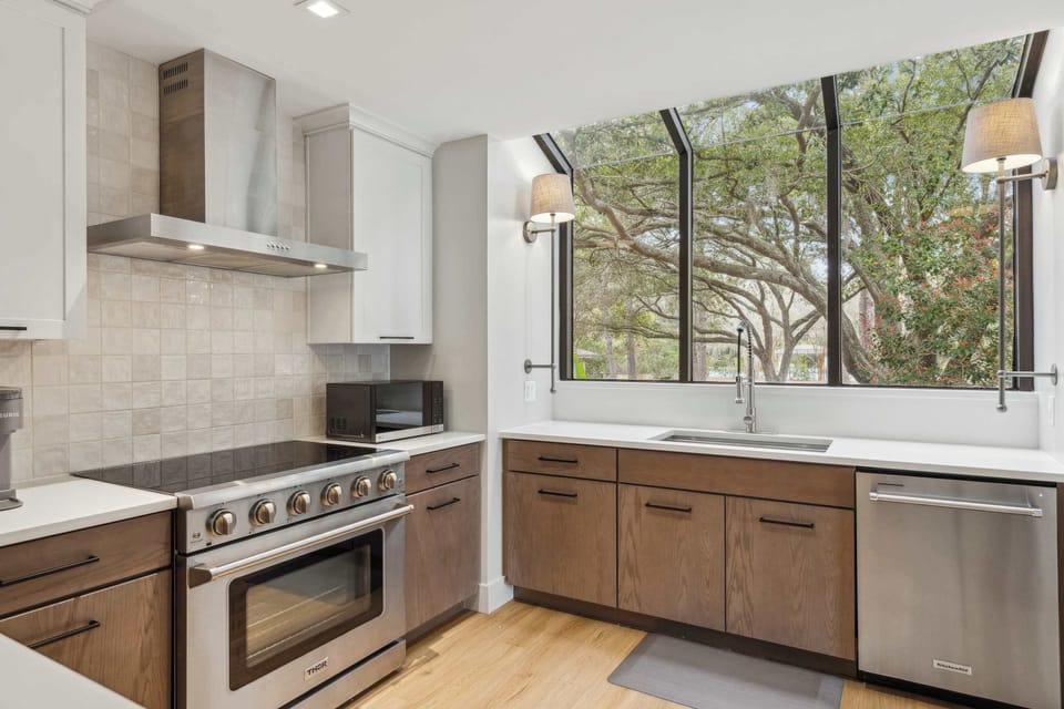 The sleek, airy kitchen offers ample space & every home comfort