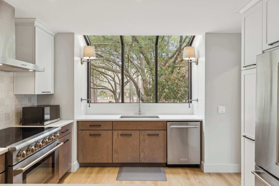 The sleek, airy kitchen offers ample space & every home comfort