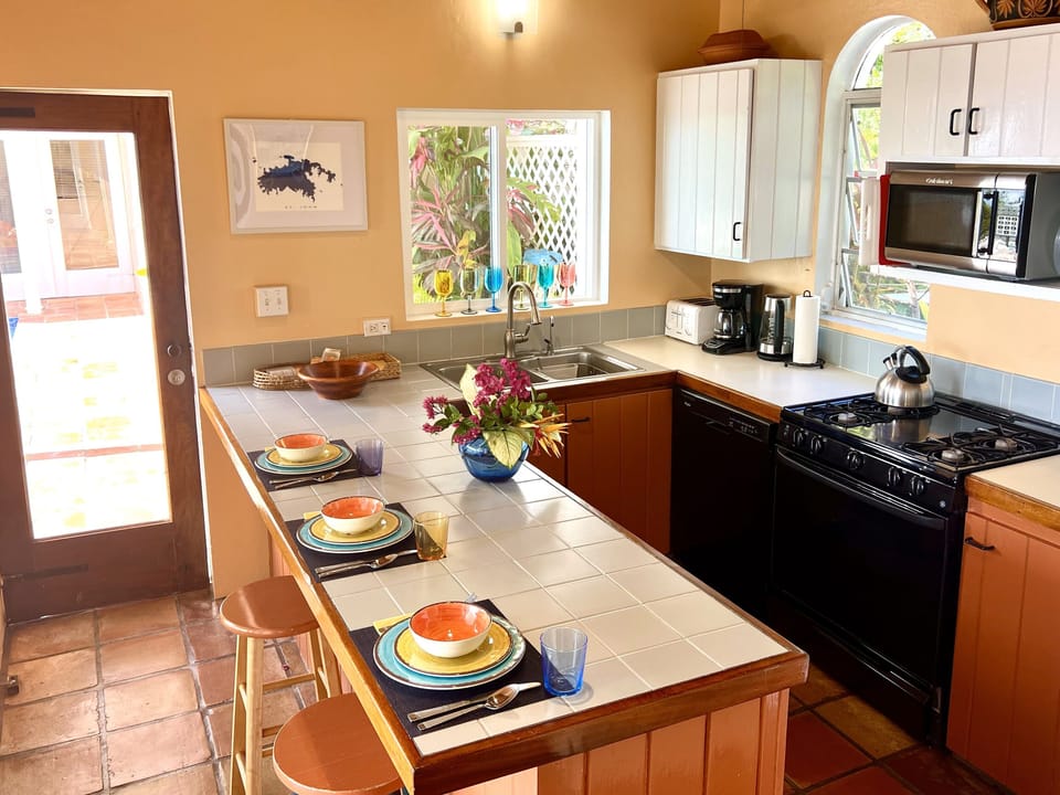 Kitchen is conveniently located by the pool and indoor/outdoor dining areas