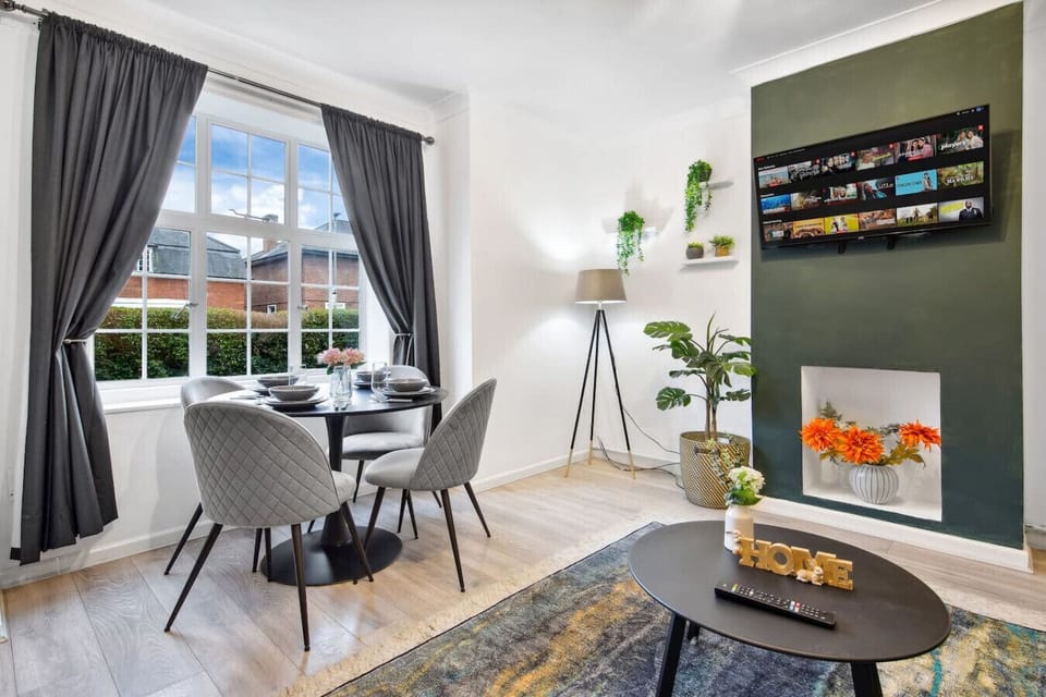 The inviting dining area features a large table with enough seating for all guests. The space is perfect for meals or entertaining.