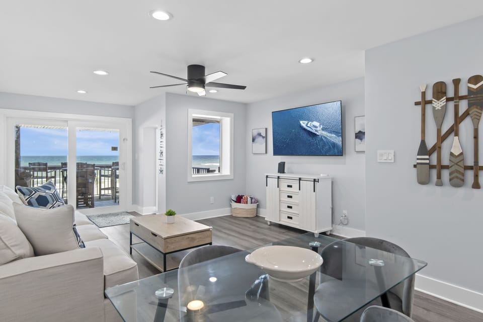 2nd Floor has the Primary Living Space with a comfortable, Gulf View living room with tons of seating around a 65" Smart TV!
