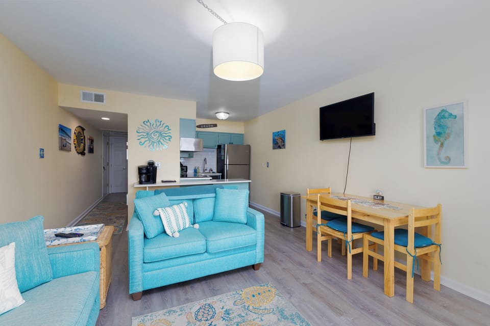 View into dining area and kitchen from balcony slider door