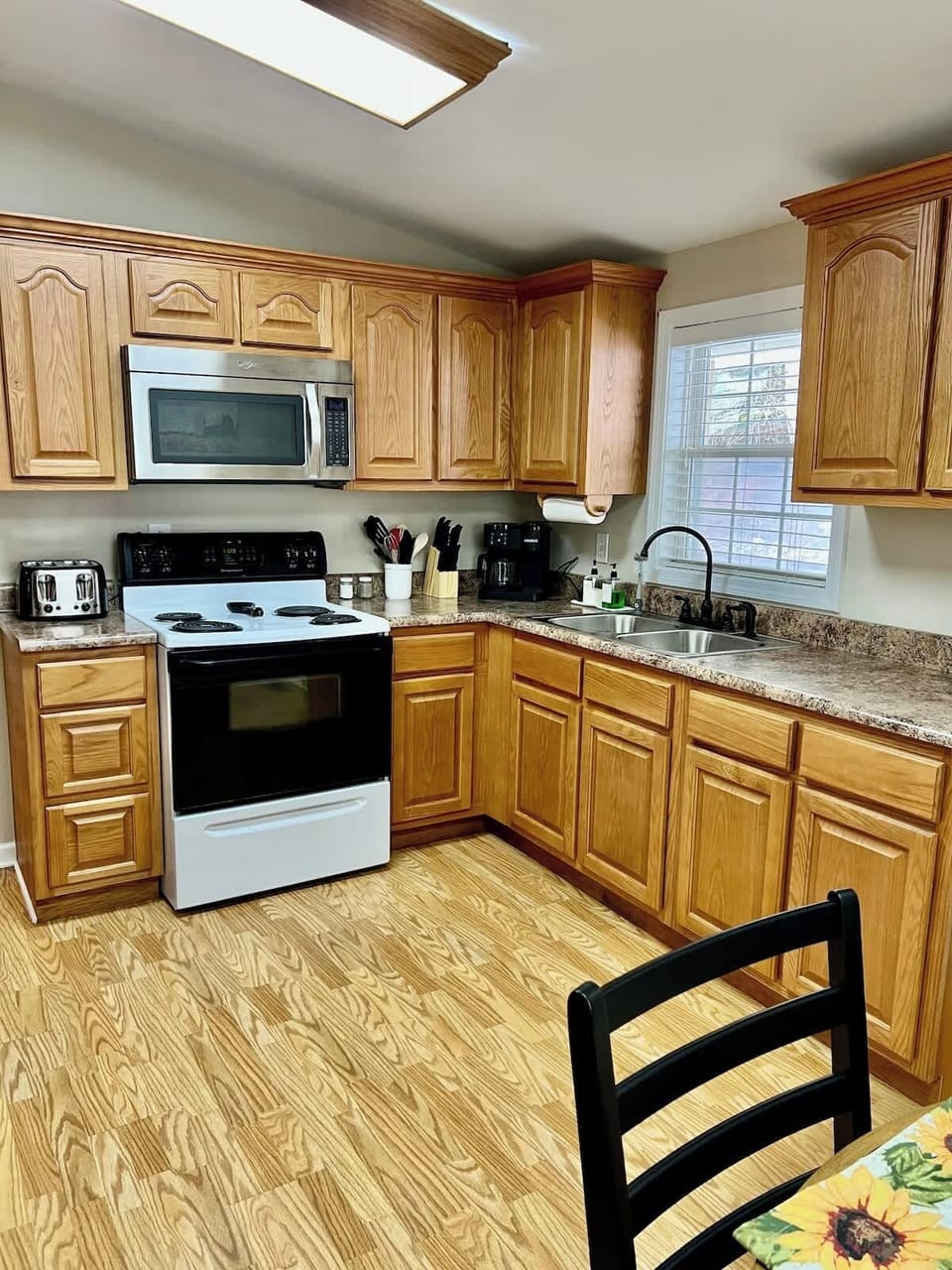The kitchen is just off the living room and has a dinette and door leading to the back porch. You will have everything you need to cook your own meals. 