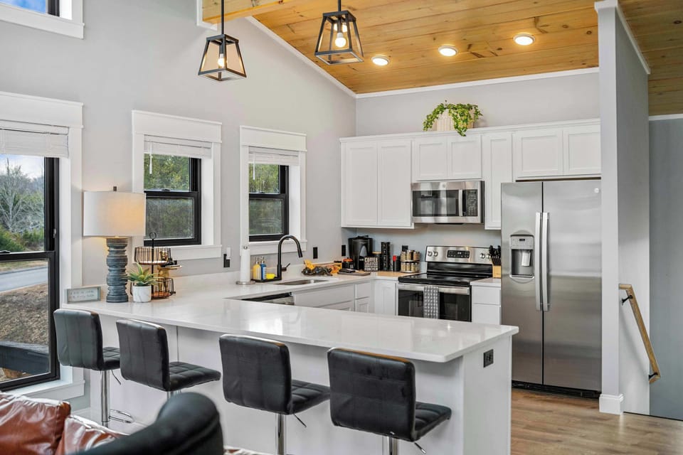 Gather comfortably in this spacious kitchen with plenty of seating for meals, games, or morning coffee. A perfect spot for the group to connect throughout the day.