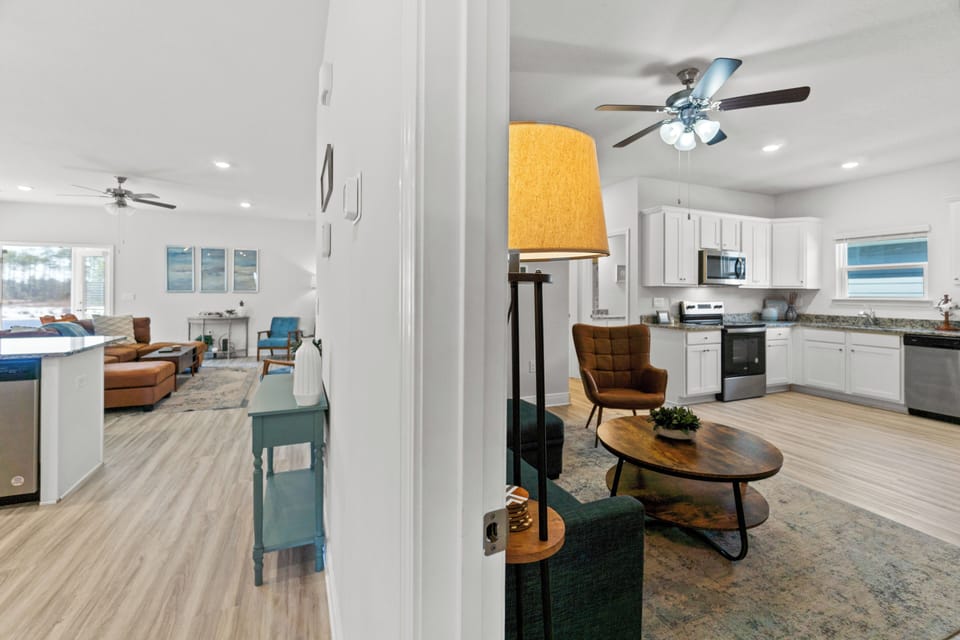 Your open-concept haven seamlessly blends modern comfort with stylish warmth, featuring a fully equipped kitchen flowing into inviting living spaces.