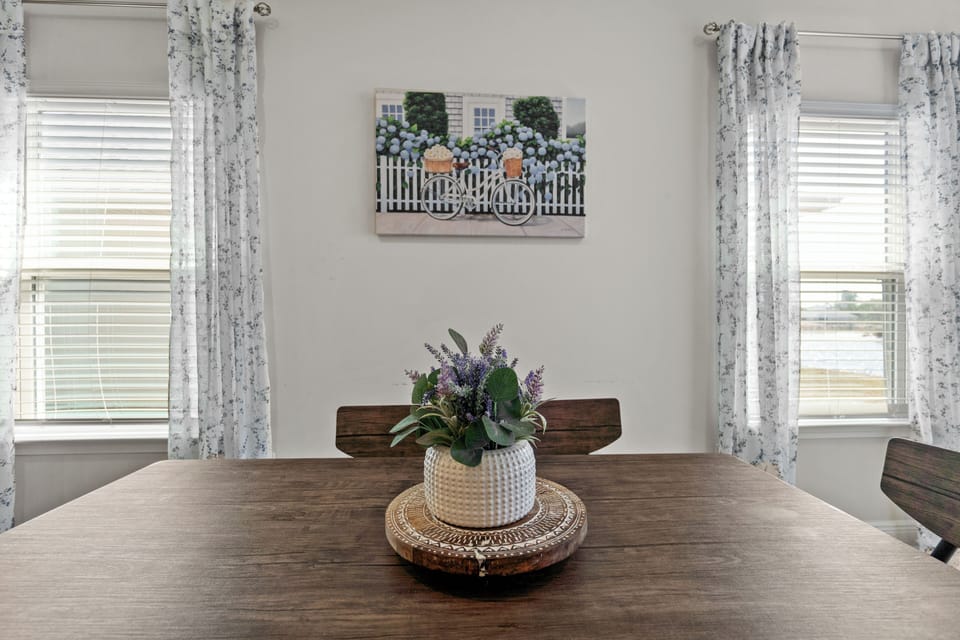 Gather around this welcoming dining table where your morning coffee and evening conversations will unfold.