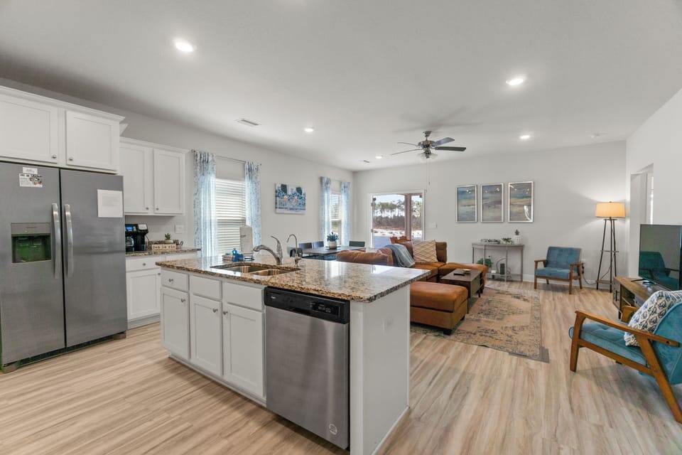 Gather in your spacious open-concept kitchen and living area, where granite countertops and stainless appliances meet comfortable seating for relaxing evenings.