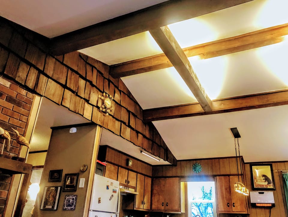 Exposed wooden rafters have dimmable lighting for the perfect mood day or night.