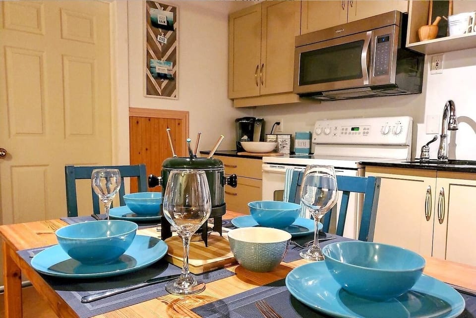 Dining table set for a nice meal with kitchen behind