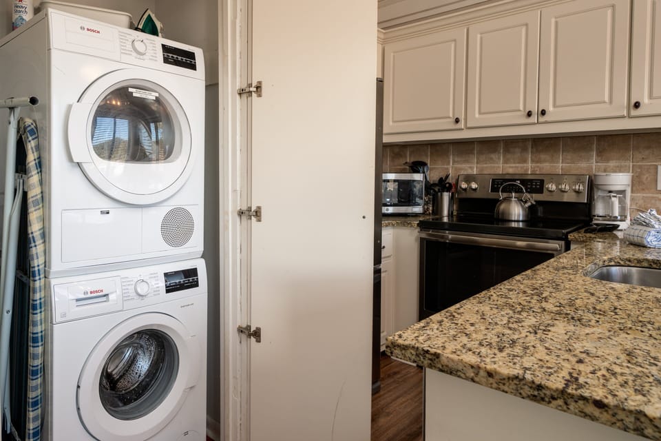 Off the kitchen is the laundry closet.  There you will find the full size stacked washer and dryer