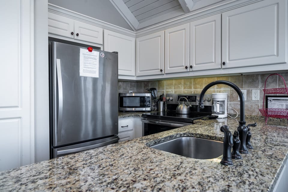 The kitchen has stainless steel appliances and granite counters