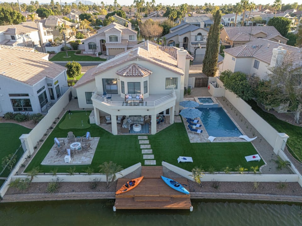 Wow! Our Val Vista Lakefront home with 5 BRs, 3 BAs, heated pool, spa. kayaks and putting green is spectacular!
