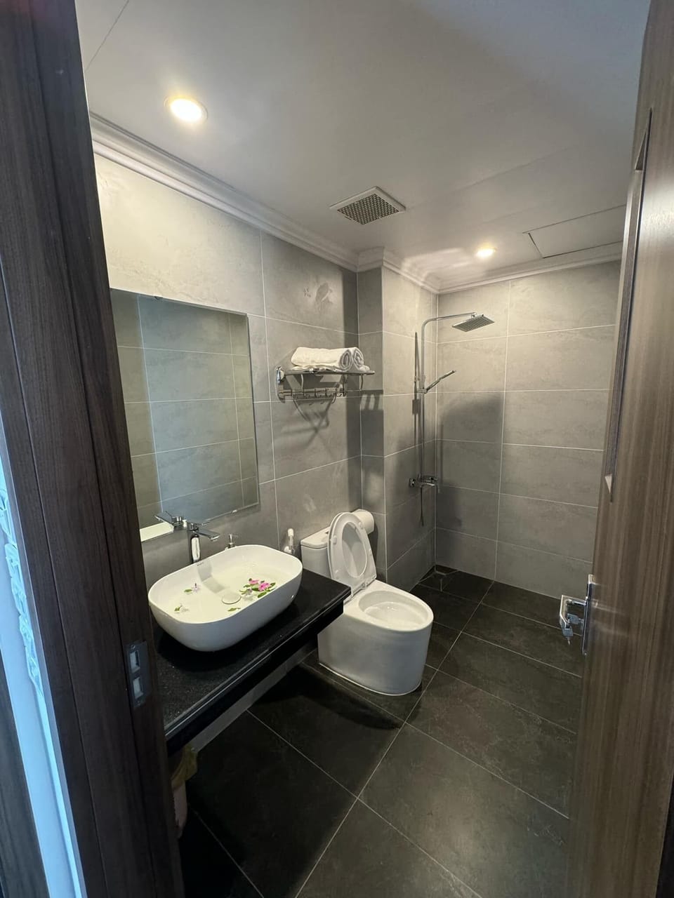 Shower, hair dryer, slippers, towels