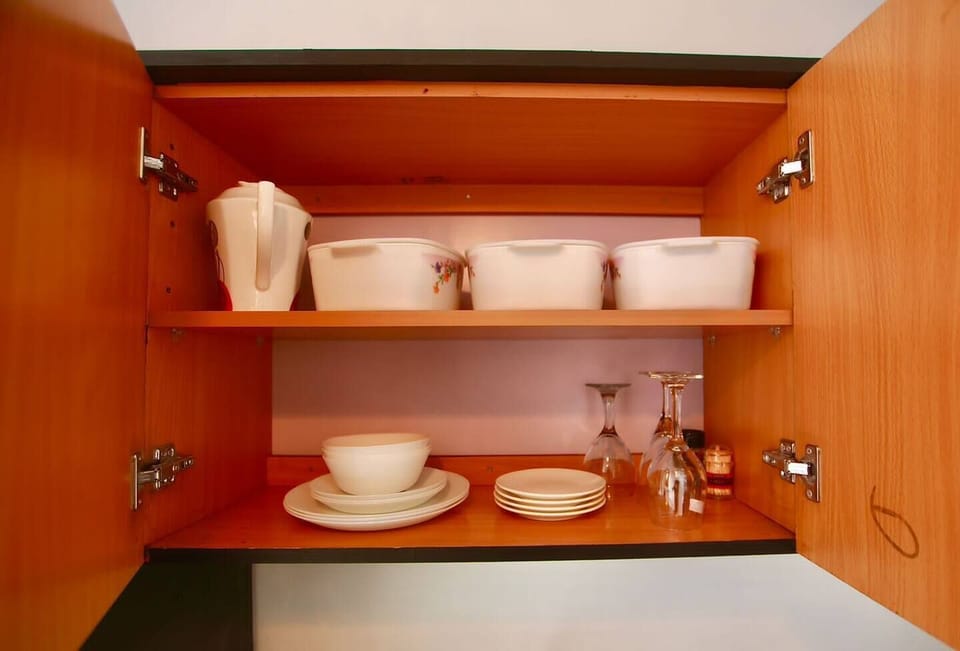 A photo of cups, plates, wine glasses. Everything needed to ensure guests can prepare and serve meals