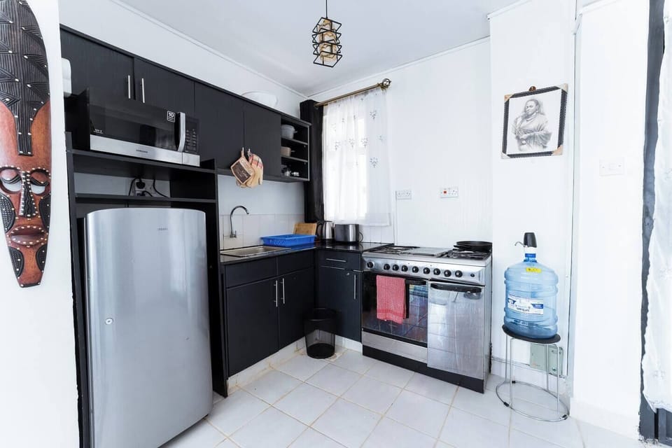 A view of the kitchen that shows the 5 burner cooker with an oven thats can prepare all kinds of meals. Also we an electric kettle and toaster are included
