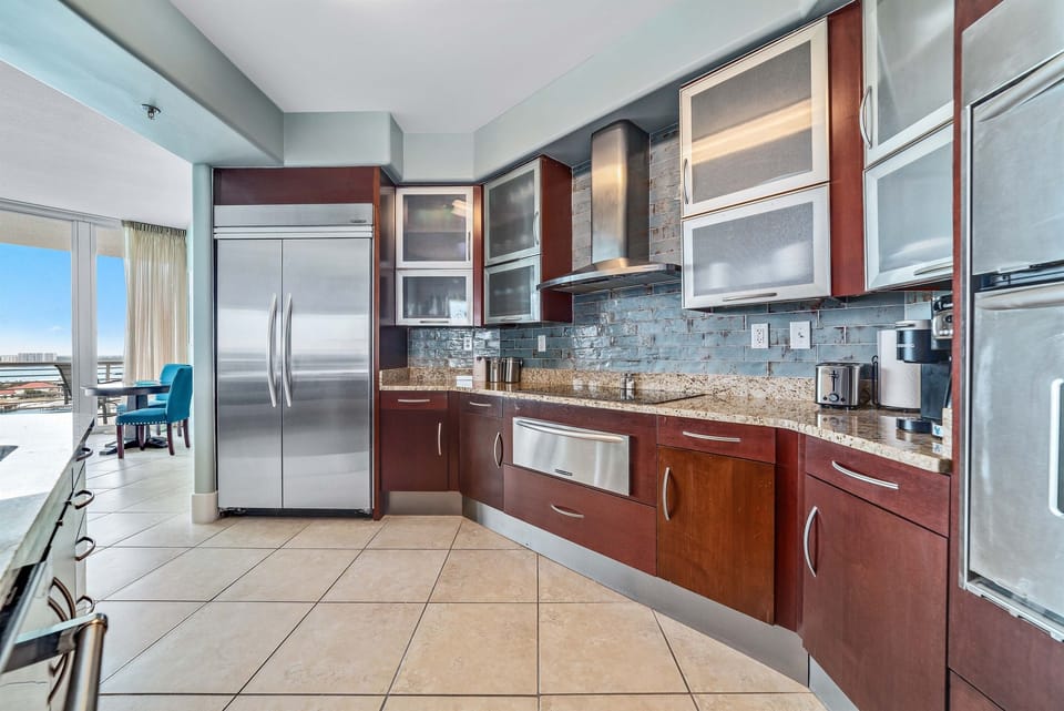 Gourmet kitchen featuring modern appliances, custom cabinetry, and a spacious open-concept design. Perfect for entertaining, this kitchen seamlessly blends style and functionality.
