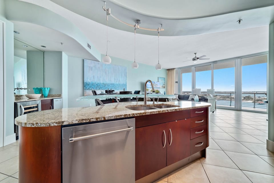 Enjoy stunning views while cooking in this beautifully designed kitchen. The open layout seamlessly connects the kitchen to the living area, creating a perfect space for gatherings and entertaining.