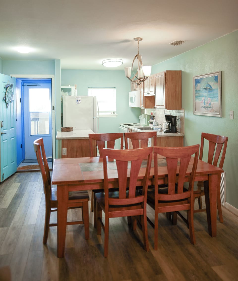 Gather around your spacious dining table for memorable meals in this welcoming kitchen space with calming coastal colors and all the essentials.