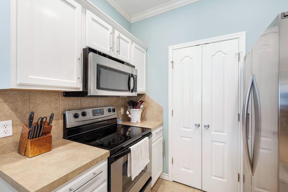 Cook your favorite meals in this fully-equipped kitchen with modern appliances and ample counter space for easy meal preparation.