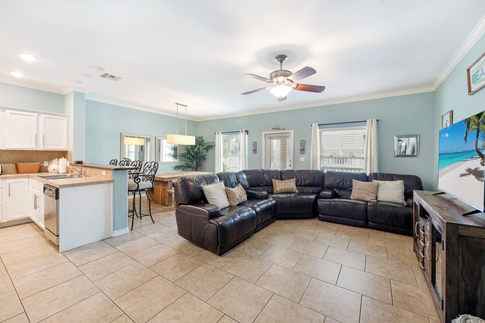 Relax in your spacious open-concept haven with plush leather sectional, modern kitchen, and coastal vibes that make every moment feel like vacation.