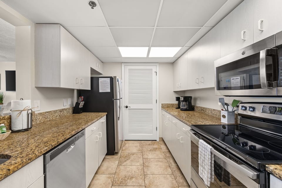 The fully equipped kitchen features granite countertops, stainless-steel appliances, and has everything you need to prepare meals for family & friends.