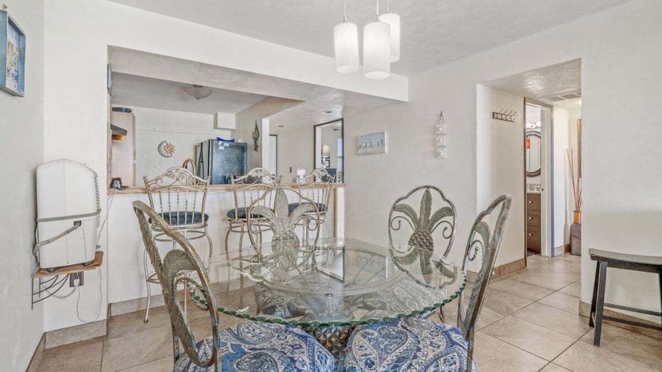 Dining area with seating for four, plus three at the bar