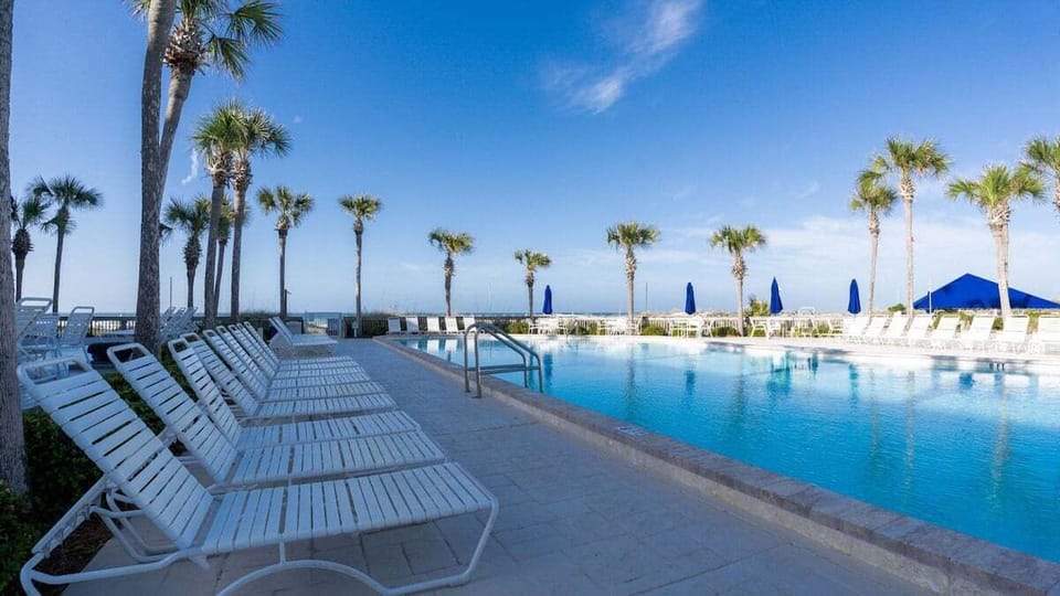 Lots of lounge chairs and picnic tables to relax in by the pool