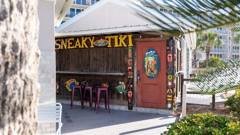 The "Sneaky Tiki" hut (open 11AM–6PM) adds tropical flair with colorful décor, carved tiki totems, and island-themed art—perfect for casual beachside refreshments.