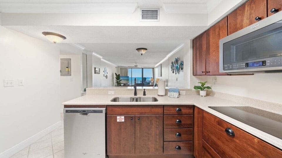 Spacious kitchen with stainless steel appliances and double sink. Enjoy ocean views from the counter while cooking or entertaining.